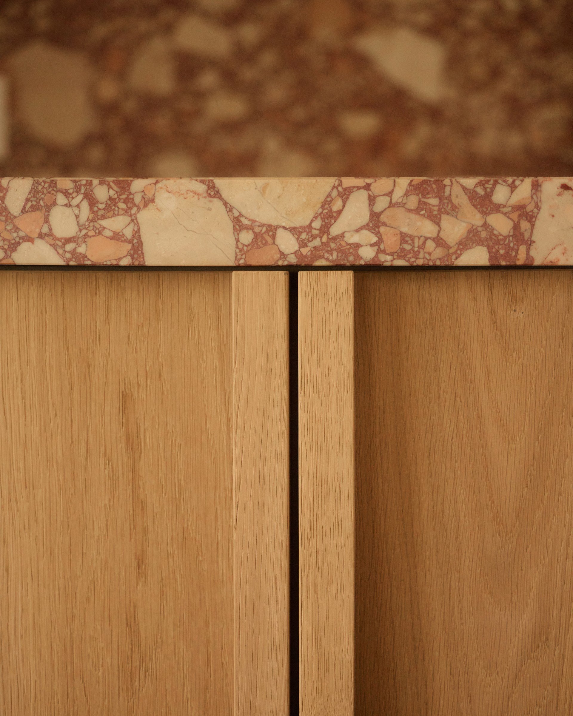 Veined stone and timber cabinetry detail